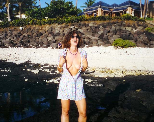 Public Dress Open , Public Dress Open, Curley Brunette With Sunglasses, Standing On Beach, Print Sundress Open To Waist